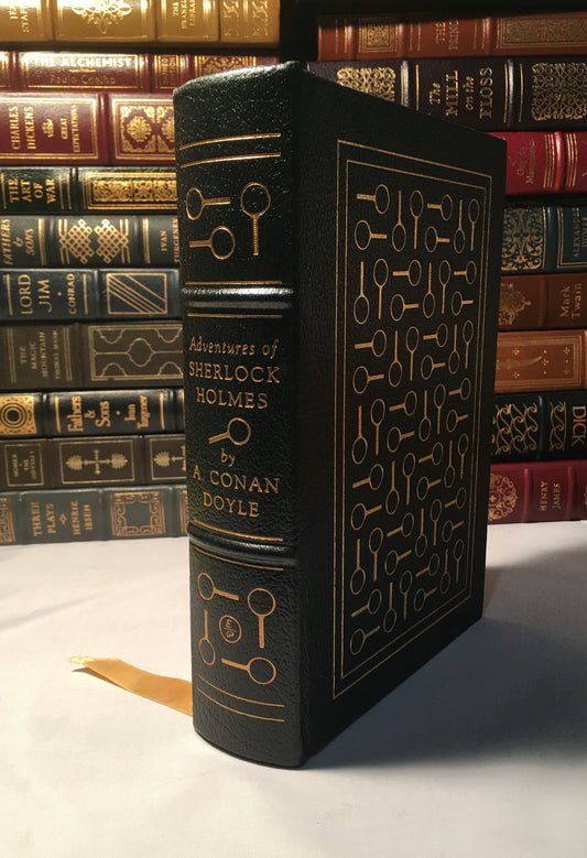 A leather-bound desk book with gold embossed letters on the cover