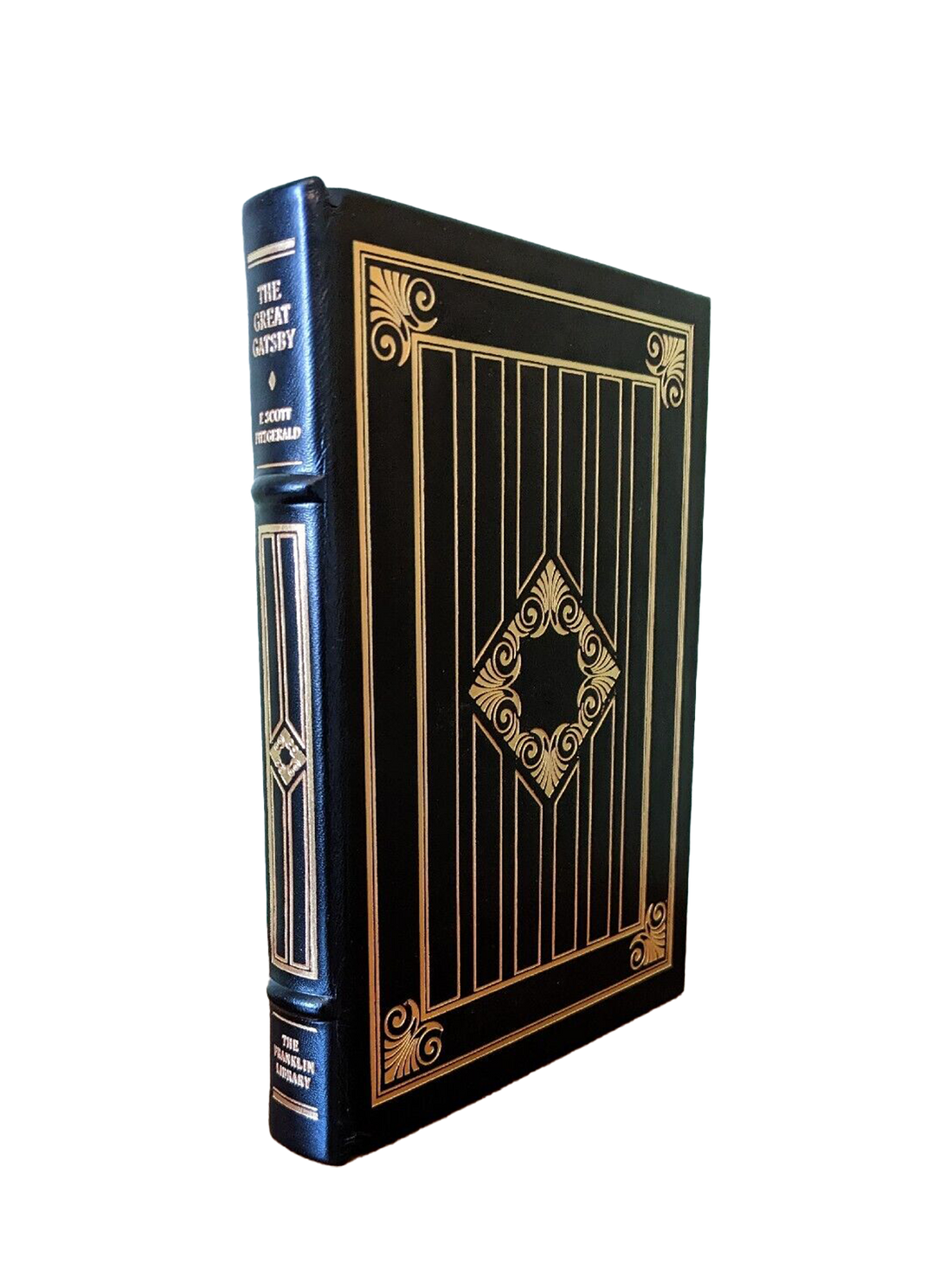 Black leather-bound edition of 'The Great Gatsby' by F. Scott Fitzgerald, featuring gold leaf detailing and a ribbon bookmark sold at Kadri Books